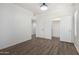 Spacious bedroom features wood floors, white walls, and a convenient walk-in closet at 21655 N 36Th Ave # 131, Glendale, AZ 85308