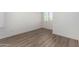Empty bedroom with neutral paint, wood flooring, and large window with white blinds at 21655 N 36Th Ave # 131, Glendale, AZ 85308