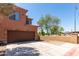 Exterior view of a two-story home featuring a brown garage door and well-manicured landscaping at 21655 N 36Th Ave # 131, Glendale, AZ 85308