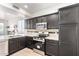Well-equipped kitchen with black cabinetry, stainless steel appliances, and granite countertops at 21655 N 36Th Ave # 131, Glendale, AZ 85308
