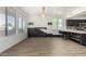 Open living space with plank flooring, contemporary lighting, and large windows for natural light at 21655 N 36Th Ave # 131, Glendale, AZ 85308