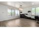 Spacious living room featuring modern lighting, black stacked stone, and luxury vinyl plank flooring at 21655 N 36Th Ave # 131, Glendale, AZ 85308