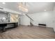 An open-concept living area with a luxury island/bar, modern light fixtures, and staircase at 21655 N 36Th Ave # 131, Glendale, AZ 85308