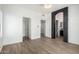 Spacious main bedroom with wood floors, stone archway and access to the ensuite bath at 21655 N 36Th Ave # 131, Glendale, AZ 85308