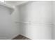Walk-in closet with white walls, wood flooring, and racks for storage and clothing at 21655 N 36Th Ave # 131, Glendale, AZ 85308