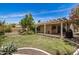 Expansive backyard features a covered patio, lush lawn, and mature landscaping at 2256 S Las Flores --, Mesa, AZ 85202