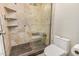 Walk-in shower with decorative tilework and a built-in seat adds a touch of luxury at 2256 S Las Flores --, Mesa, AZ 85202