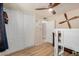 This bedroom features modern laminate flooring, ceiling fan, and a spacious closet at 2256 S Las Flores --, Mesa, AZ 85202