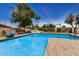 Bright community pool featuring clear blue water, mature trees, and ample seating, perfect for relaxation and community enjoyment at 2256 S Las Flores --, Mesa, AZ 85202