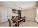 Bright dining room features a large wood table, stylish light fixtures, and built-in cabinets, creating an inviting space at 2256 S Las Flores --, Mesa, AZ 85202