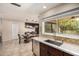 This dining room features wood table, modern light fixtures, with a view of the backyard and stainless kitchen sink at 2256 S Las Flores --, Mesa, AZ 85202