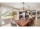 Open dining area shows wood table, modern light fixtures, and sliding glass door leading to the outdoor patio at 2256 S Las Flores --, Mesa, AZ 85202