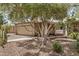 Exterior of tan brick home with covered porch and a swing at 2256 S Las Flores --, Mesa, AZ 85202