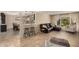 Open living room showcases tile floors, leather couch, and a bar to dining area at 2256 S Las Flores --, Mesa, AZ 85202