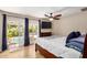 The main bedroom features hardwood floors, a ceiling fan, and direct access to the backyard at 2256 S Las Flores --, Mesa, AZ 85202