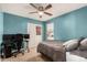 Cozy bedroom with blue walls, a ceiling fan, and a desk at 25420 W Park Ave, Buckeye, AZ 85326