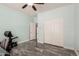 Bedroom featuring a ceiling fan, closet doors, fitness bench and an open doorway at 25420 W Park Ave, Buckeye, AZ 85326