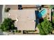 A home's tile roof, surrounded by greenery and desert landscaping, is complemented by a refreshing backyard pool at 2615 N 123Rd Dr, Avondale, AZ 85392