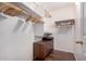 Organized walk-in closet featuring wooden drawers and ample hanging space, perfect for storage at 2615 N 123Rd Dr, Avondale, AZ 85392