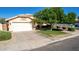 Charming home featuring a two-car garage, well-maintained lawn, mature trees, and inviting curb appeal at 2615 N 123Rd Dr, Avondale, AZ 85392