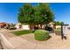 Beautiful home with mature landscaping providing shade and privacy, enhancing its curb appeal at 2615 N 123Rd Dr, Avondale, AZ 85392