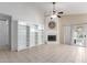 Spacious living room with a cozy fireplace and built-in bookshelves, perfect for relaxing or entertaining at 2615 N 123Rd Dr, Avondale, AZ 85392