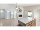 Bright living area featuring a fireplace, a ceiling fan, tile floors and a kitchen island with breakfast bar at 2615 N 123Rd Dr, Avondale, AZ 85392