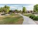 Well-maintained community park with paved walkways, lush landscaping, and mature shade trees; ideal for recreation at 2741 E Odessa St, Mesa, AZ 85213
