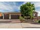 Charming home with a three-car garage, stone accents, and a well-manicured front yard at 2741 E Odessa St, Mesa, AZ 85213