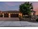 Charming home with a three-car garage, stone accents, and a well-manicured front yard at 2741 E Odessa St, Mesa, AZ 85213