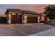 Attached three-car garage with brick paved driveway and tile roof at 2741 E Odessa St, Mesa, AZ 85213
