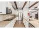 Bright kitchen with stainless appliances, white cabinets, wooden beams, and granite countertops at 2741 E Odessa St, Mesa, AZ 85213