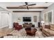 Cozy living room featuring exposed beams, hardwood floors, and a ceiling fan at 2741 E Odessa St, Mesa, AZ 85213