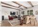 Cozy living room featuring exposed beams, hardwood floors, and a ceiling fan at 2741 E Odessa St, Mesa, AZ 85213