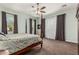 Spacious main bedroom with a four-poster bed, neutral carpet, and lots of natural light at 2741 E Odessa St, Mesa, AZ 85213