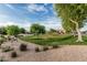 Beautiful community park with manicured lawn, walking trails, mature trees and a playground visible in background at 2741 E Odessa St, Mesa, AZ 85213
