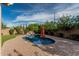 Backyard pool with rock feature and lush landscaping at 2741 E Odessa St, Mesa, AZ 85213