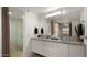 Bathroom with double vanity, granite countertop, framed mirror, and stand-up shower at 3031 N Civic Center Plz # 355, Scottsdale, AZ 85251
