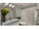 Bright bathroom with updated vanity, contemporary fixtures, decorative mirror, and shower with curtain at 3031 N Civic Center Plz # 355, Scottsdale, AZ 85251