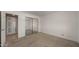 A large bedroom with carpet flooring, a closet, and an ensuite bathroom entrance at 3031 N Civic Center Plz # 355, Scottsdale, AZ 85251