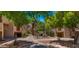 Exterior view of apartment complex with mature landscaping, pathway, and water feature at 3031 N Civic Center Plz # 355, Scottsdale, AZ 85251