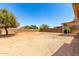 Wide open backyard with a covered patio, mature trees and block fence offering privacy at 30601 N Royal Oak Way, San Tan Valley, AZ 85143