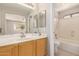 Well-lit bathroom with a vanity, mirror, bathtub and shower combination at 30601 N Royal Oak Way, San Tan Valley, AZ 85143