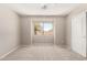 Bright bedroom featuring neutral walls, carpet, and a window view at 30601 N Royal Oak Way, San Tan Valley, AZ 85143