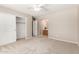 Spacious carpeted bedroom featuring a ceiling fan, closet, and entrance to the bathroom at 30601 N Royal Oak Way, San Tan Valley, AZ 85143