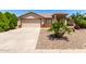 Charming single-story home featuring a two-car garage and desert landscaping at 30601 N Royal Oak Way, San Tan Valley, AZ 85143