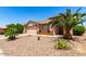 Single-story house featuring a two-car garage, desert landscaping, and a clear blue sky at 30601 N Royal Oak Way, San Tan Valley, AZ 85143