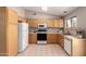 Well-lit kitchen with ample cabinetry, standard appliances, and tile flooring at 30601 N Royal Oak Way, San Tan Valley, AZ 85143