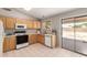 Kitchen with classic cabinetry, appliances, and access to the outdoors at 30601 N Royal Oak Way, San Tan Valley, AZ 85143