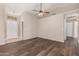 Living room with sleek wood floors, ceiling fan, and neutral wall color at 30601 N Royal Oak Way, San Tan Valley, AZ 85143